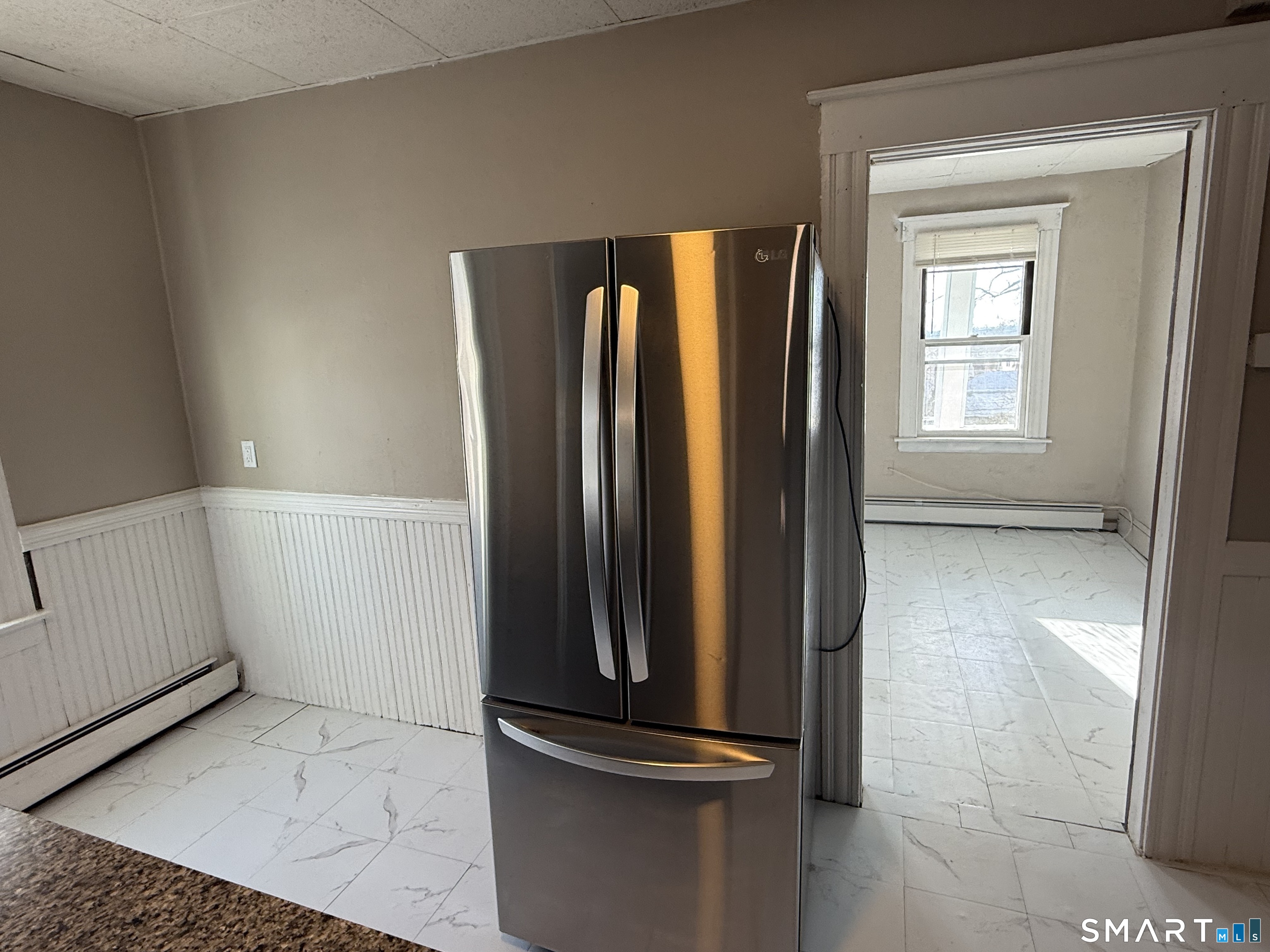 154 Daly Avenue, Unit 3 New Britain, CT 06051 - Photo 17 of 25 a view of a room with wooden floor and windows