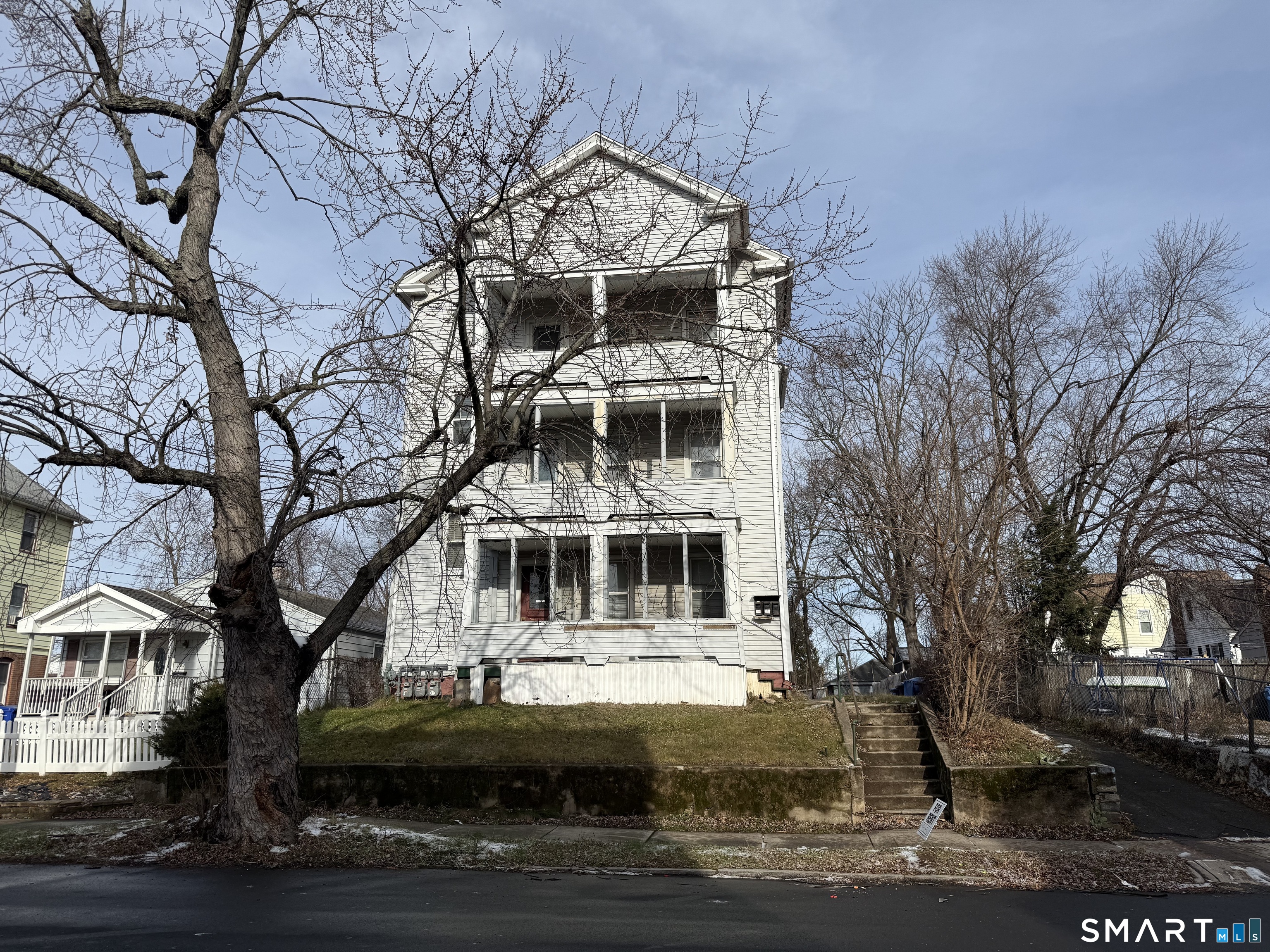 154 Daly Avenue, Unit 3 New Britain, CT 06051 - Photo 2 of 25 a front view of a residential apartment building with a yard