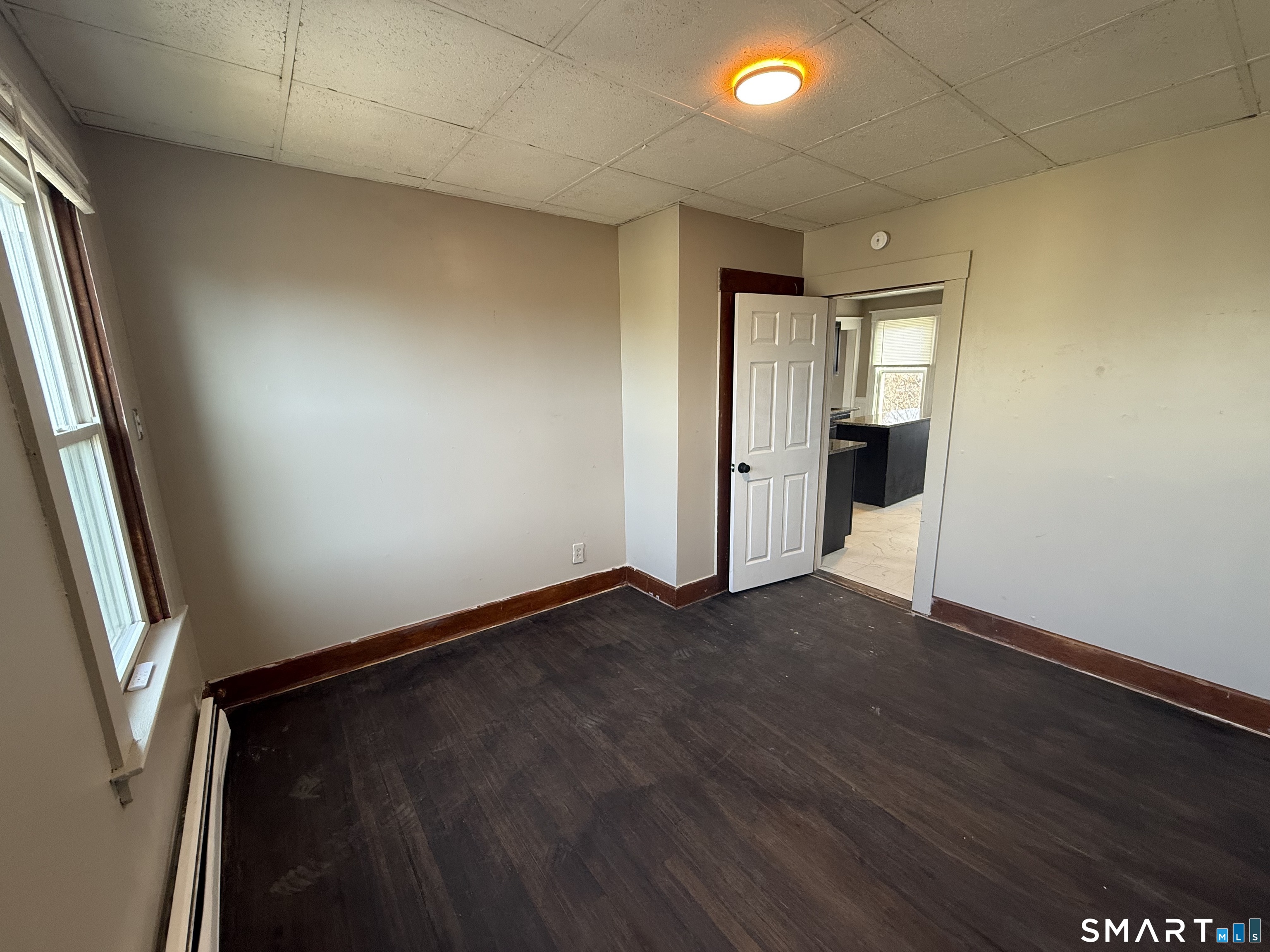 154 Daly Avenue, Unit 3 New Britain, CT 06051 - Photo 22 of 25 an empty room with wooden floor and entrance