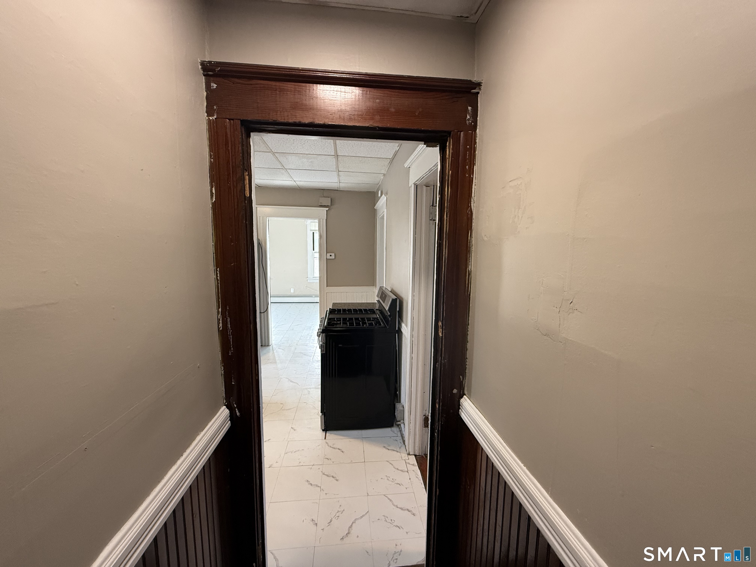 154 Daly Avenue, Unit 3 New Britain, CT 06051 - Photo 5 of 25 a view of a hallway and a livingroom with wooden floor