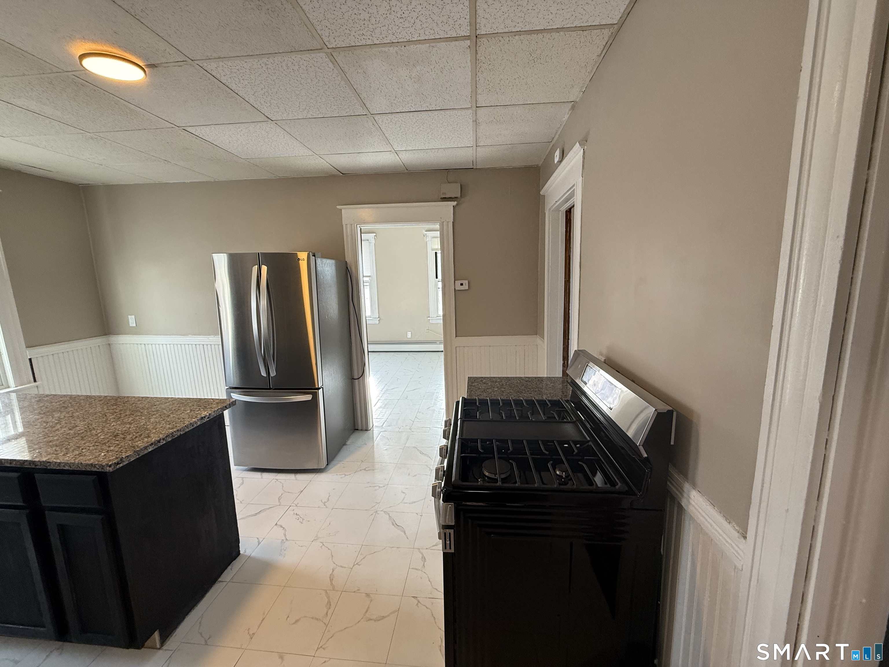 154 Daly Avenue, Unit 3 New Britain, CT 06051 - Photo 6 of 25 a kitchen with granite countertop a refrigerator and a stove