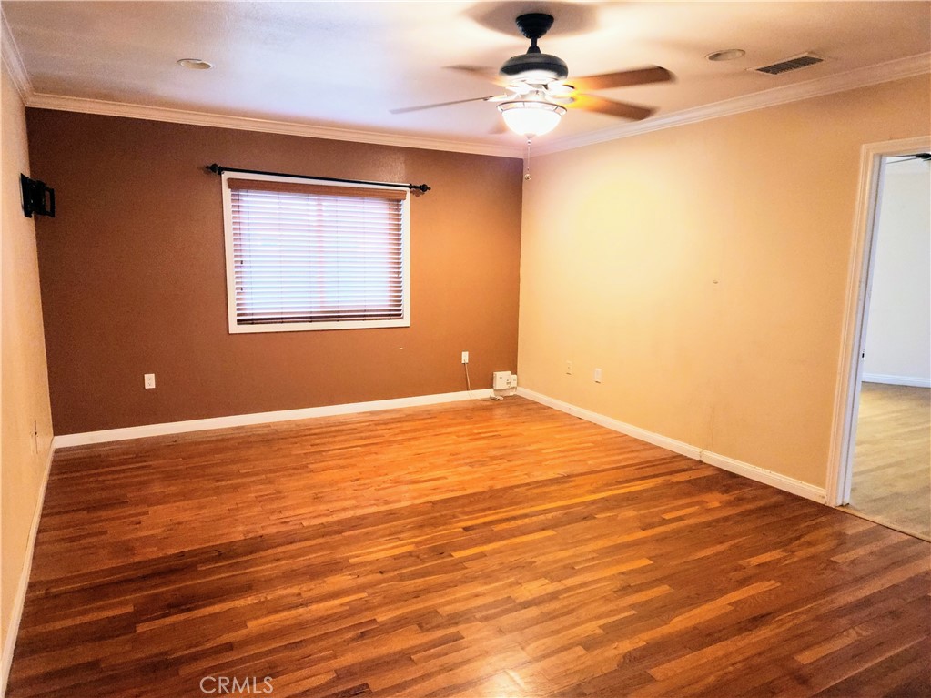 1325 West 34th Street Long Beach, CA 90810 - Photo 12 of 35 a view of an empty room with wooden floor and a window