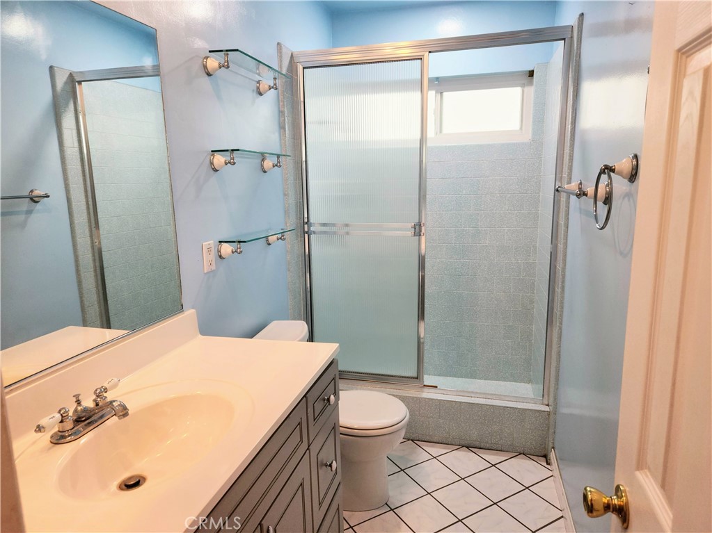 1325 West 34th Street Long Beach, CA 90810 - Photo 16 of 35 a bathroom with a granite countertop sink toilet and shower