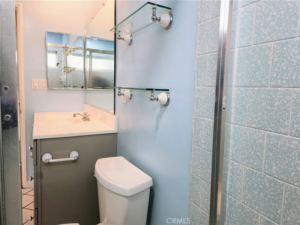 1325 West 34th Street Long Beach, CA 90810 - Photo 17 of 35 a bathroom with a sink a toilet and shower