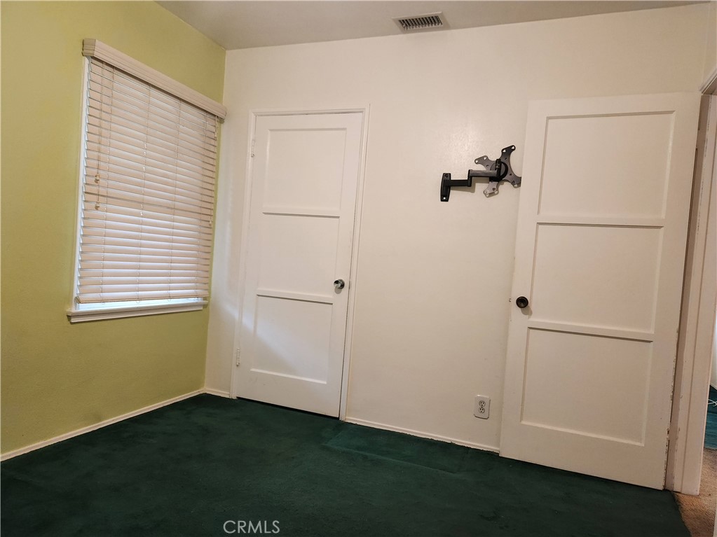 1325 West 34th Street Long Beach, CA 90810 - Photo 18 of 35 a view of an empty room with closet and a window