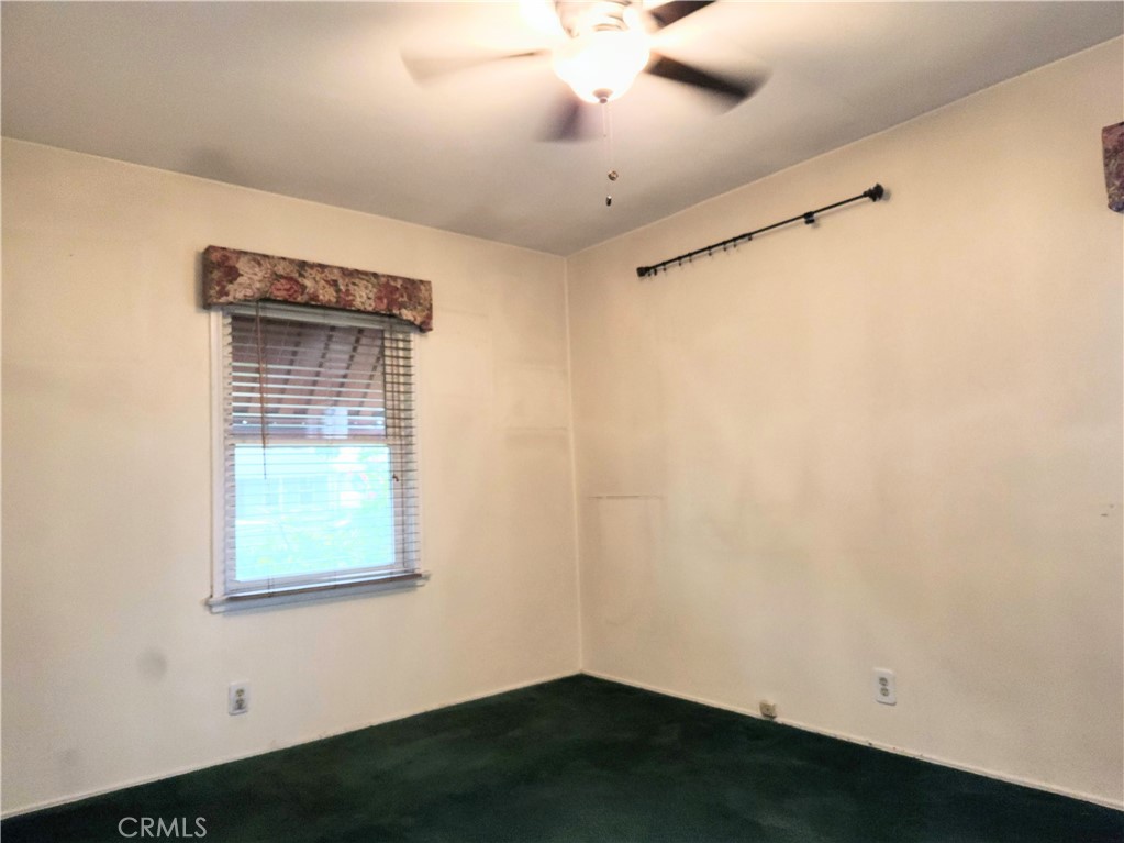 1325 West 34th Street Long Beach, CA 90810 - Photo 20 of 35 an empty room with a window and a ceiling fan