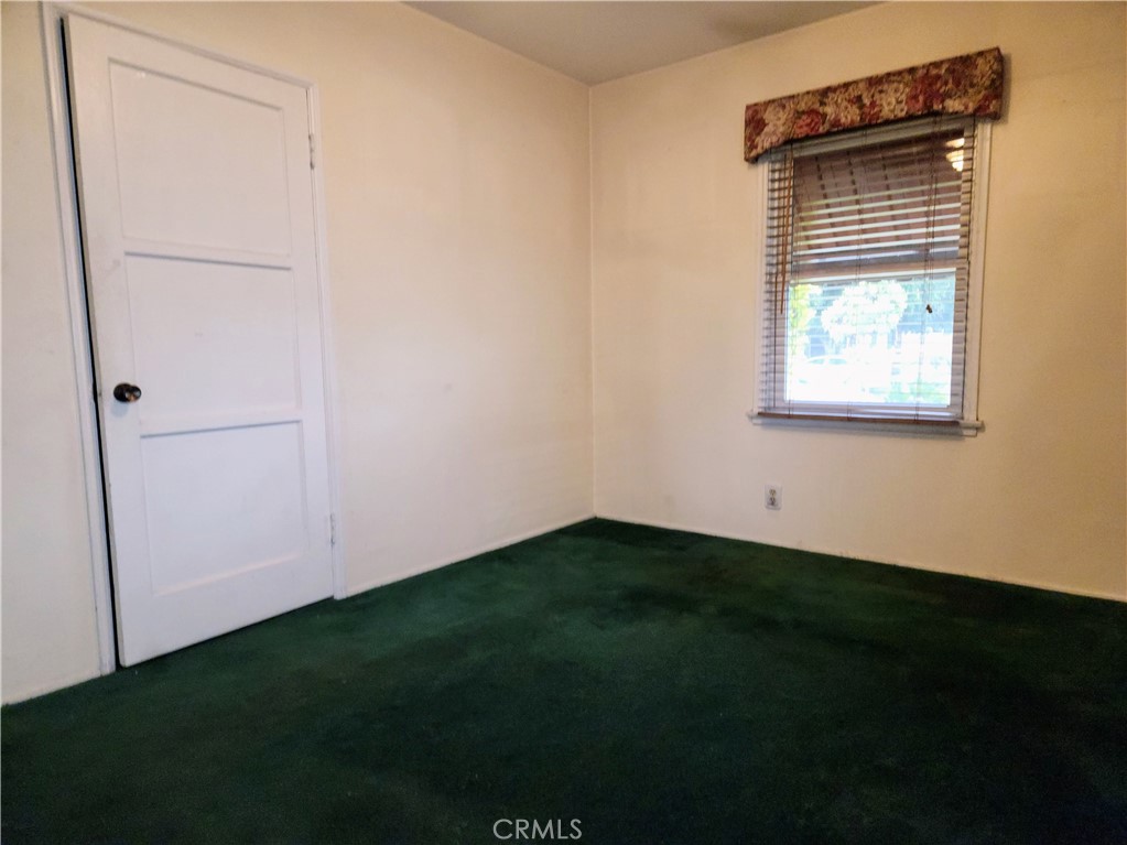 1325 West 34th Street Long Beach, CA 90810 - Photo 21 of 35 a view of an empty room with wooden floor and a window