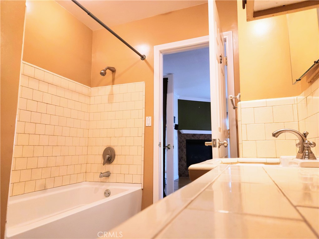 1325 West 34th Street Long Beach, CA 90810 - Photo 22 of 35 a bathroom with a bathtub and a shower