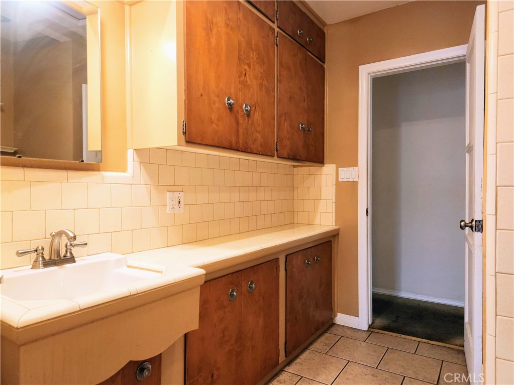 1325 West 34th Street Long Beach, CA 90810 - Photo 23 of 35 a bathroom with a sink and a mirror