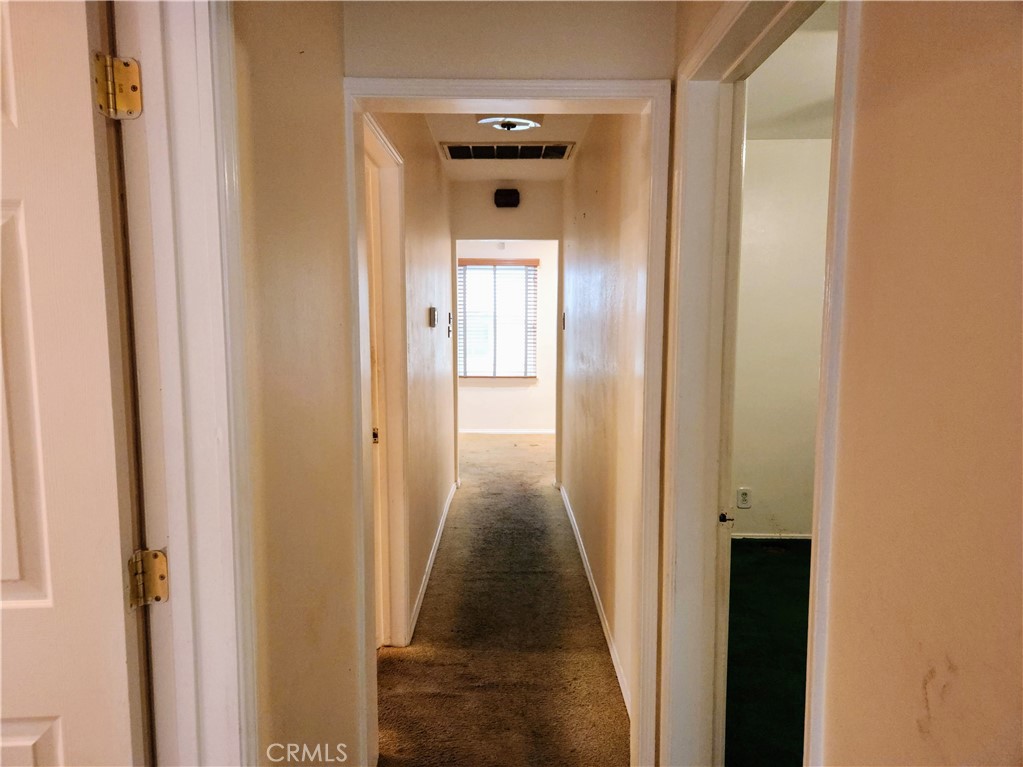 1325 West 34th Street Long Beach, CA 90810 - Photo 24 of 35 a view of a hallway with a wooden door