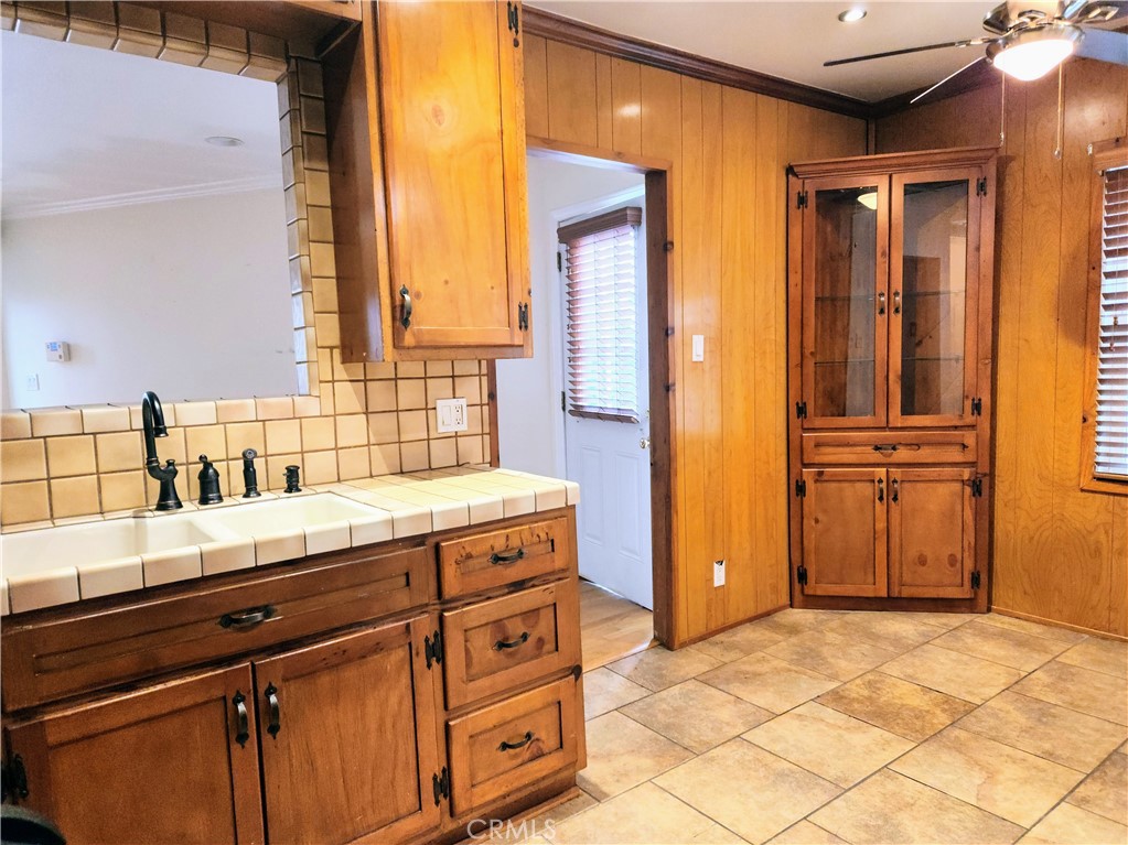 1325 West 34th Street Long Beach, CA 90810 - Photo 5 of 35 a bathroom with a granite countertop sink and a mirror