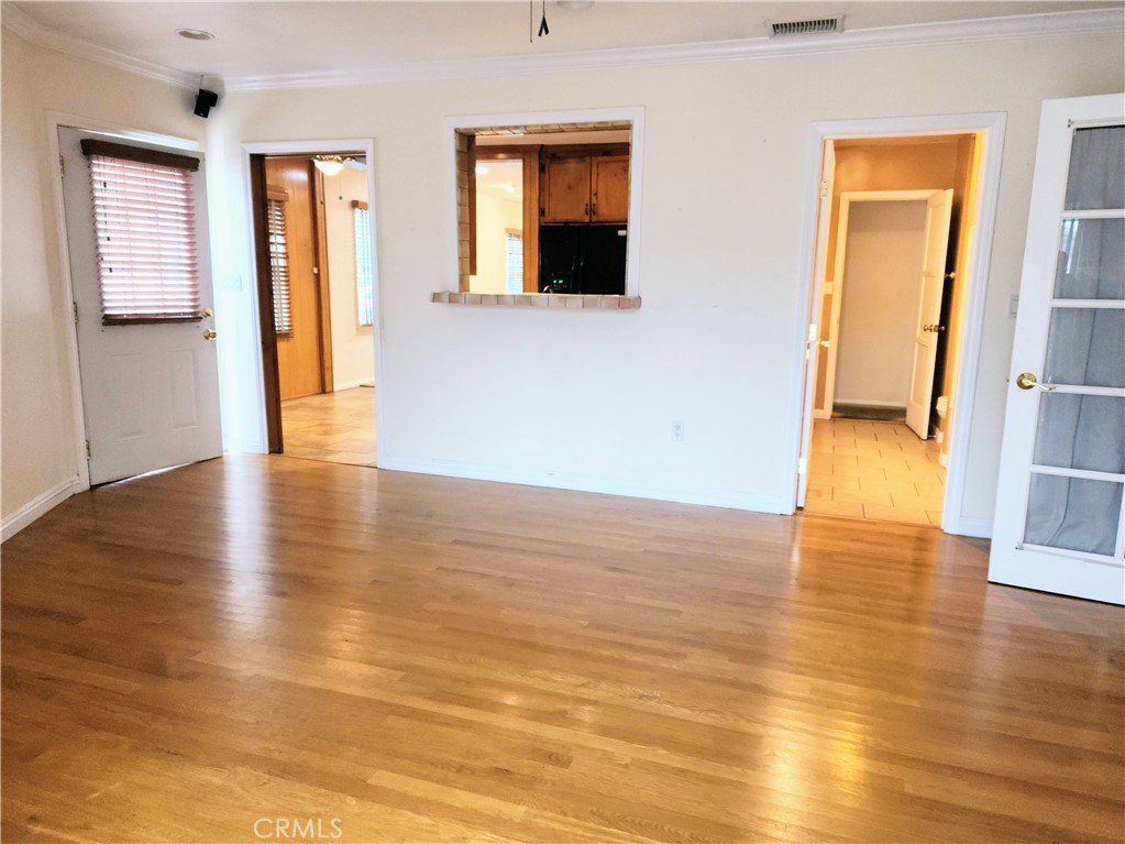 1325 West 34th Street Long Beach, CA 90810 - Photo 9 of 35 a view of an empty room with wooden floor and a window