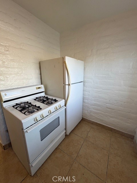 66351 First Street, Unit 2 Desert Hot Springs, CA 92240 - Photo 11 of 16 a stove top oven sitting inside of a kitchen