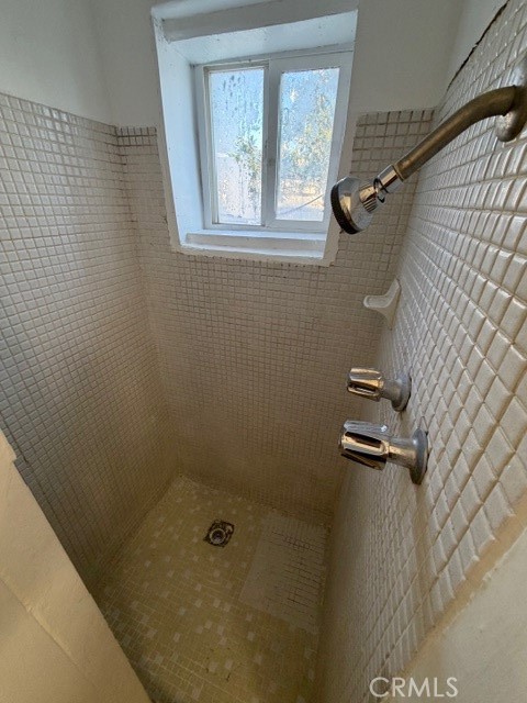 66351 First Street, Unit 2 Desert Hot Springs, CA 92240 - Photo 14 of 16 a bathroom with a shower