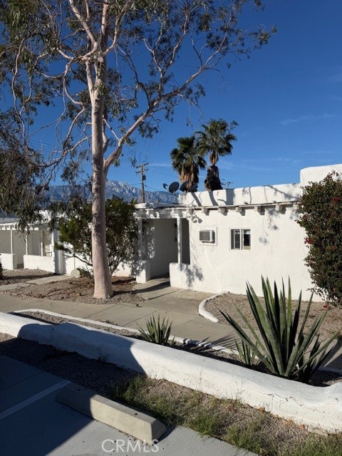 66351 First Street, Unit 2 Desert Hot Springs, CA 92240 - Photo 2 of 16 a view of a house with a yard