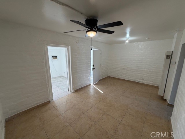 66351 First Street, Unit 2 Desert Hot Springs, CA 92240 - Photo 6 of 16 an empty room with a ceiling fan and window