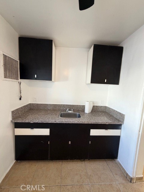 66351 First Street, Unit 2 Desert Hot Springs, CA 92240 - Photo 9 of 16 a bathroom with a granite countertop sink a mirror and bathtub