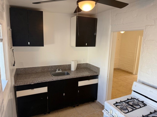 66351 First Street, Unit 2 Desert Hot Springs, CA 92240 - Photo 10 of 16 a bathroom with a granite countertop sink and a mirror