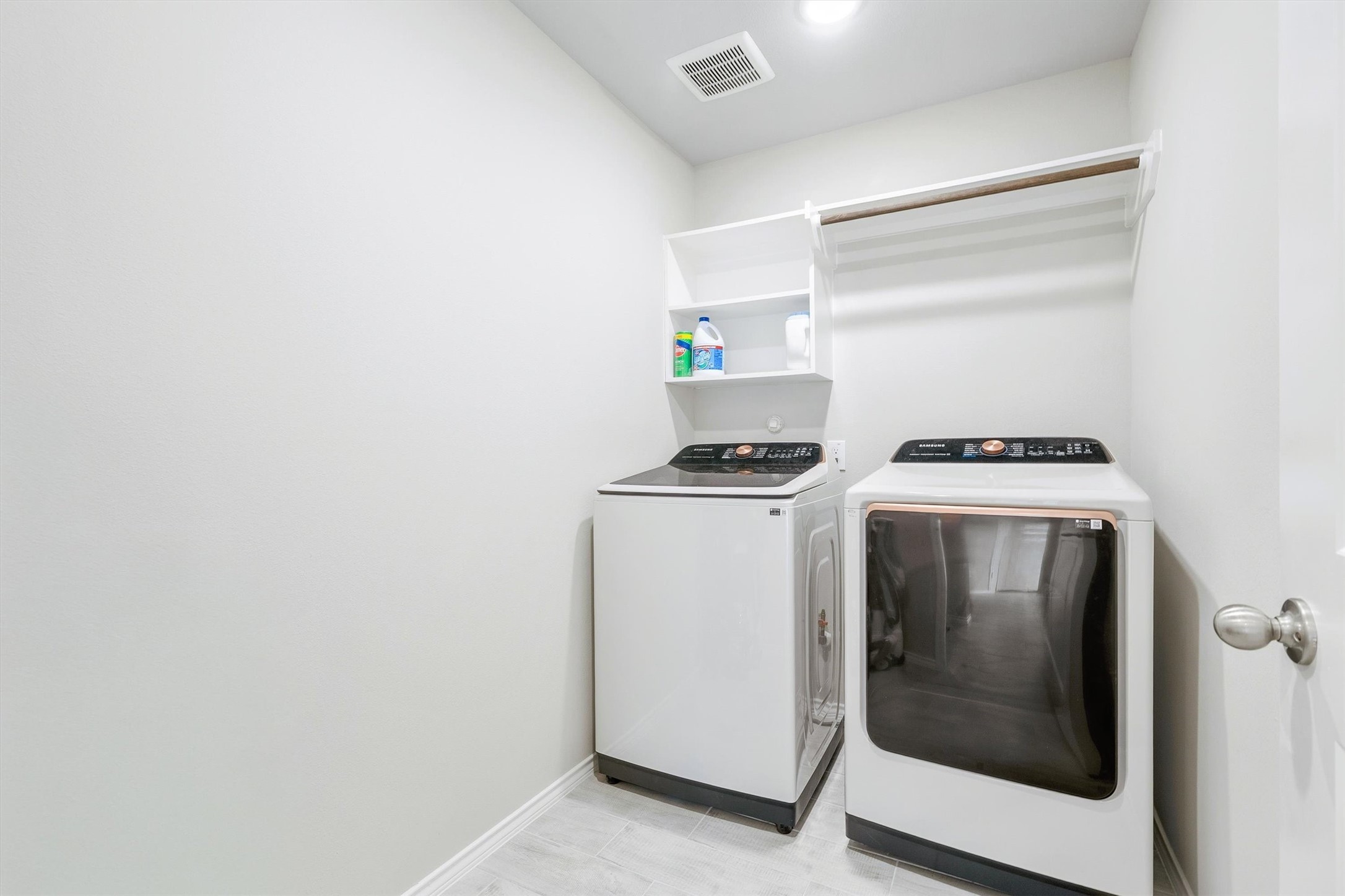 17270 Wild Watermelon Way Conroe, TX 77302 - Photo 22 of 28 A dedicated laundry room with built-in shelving and a hanging rod makes laundry day a little less of a chore. Gas and electric washer and dryer connections available, so you have options.