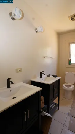 a bathroom with a black and white checkered floor