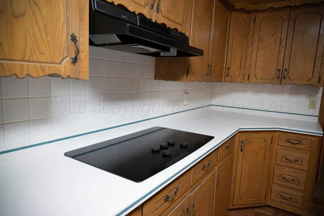a kitchen with stainless steel appliances a refrigerator and a counter top
