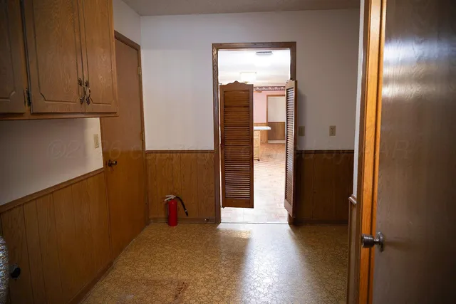 a view of a utility room with cabinet and stairs