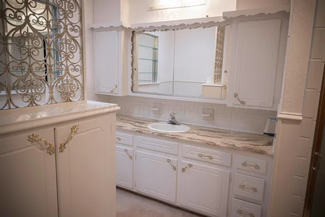 a bathroom with a sink and a window