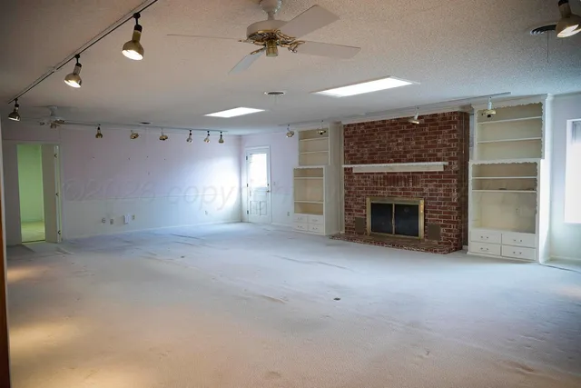 an empty room with windows and entrance