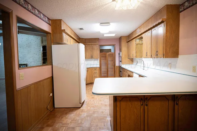 a kitchen with granite countertop a sink and cabinets
