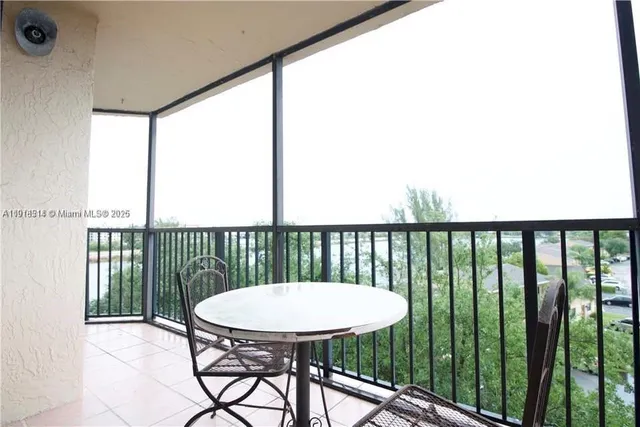 a view of a balcony with a table and chairs