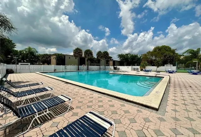 a view of a backyard with sitting area