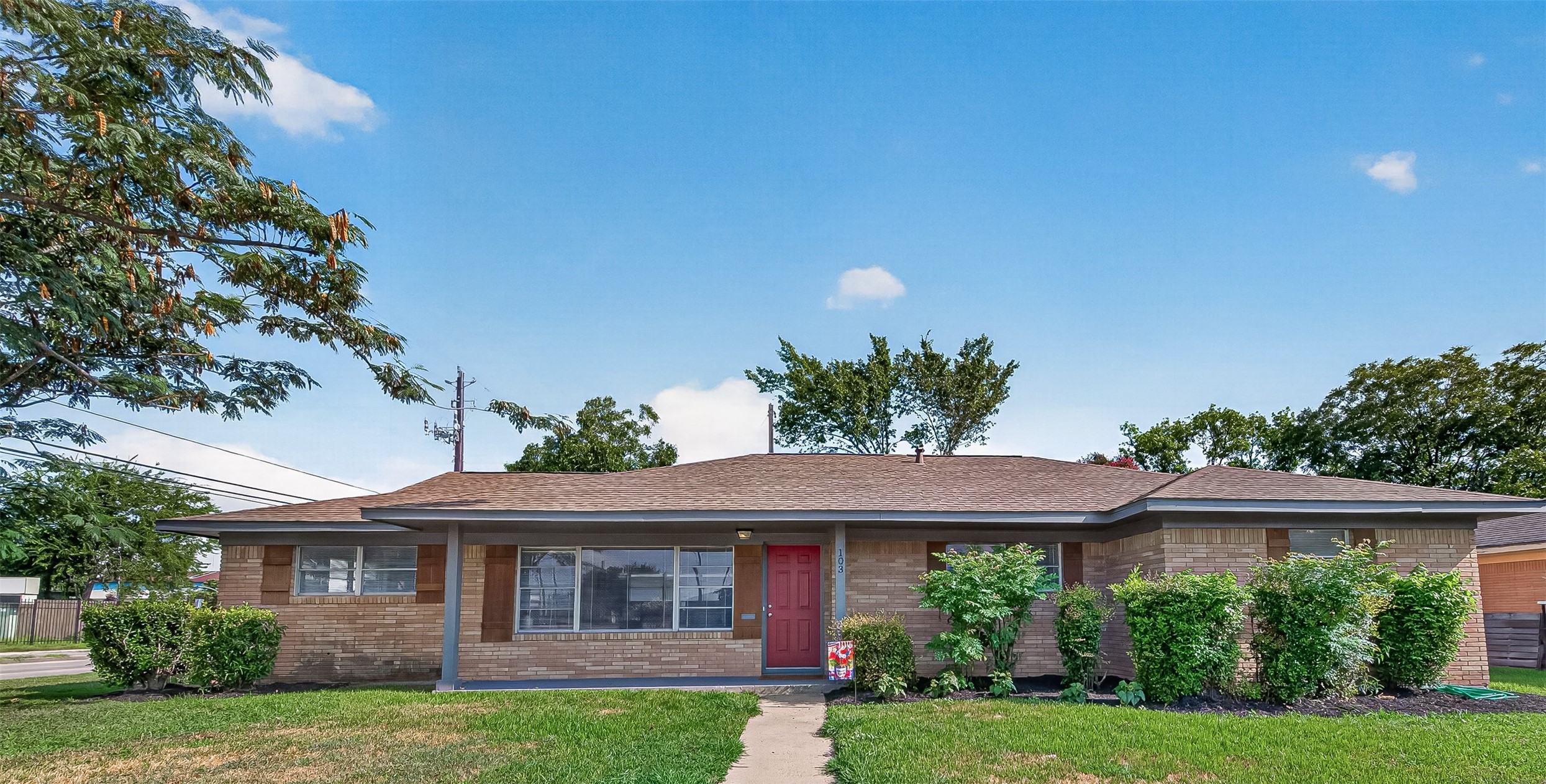 Charming single-story brick home with a welcoming red door and lush landscaping, offering great curb appeal and a cozy front porch.  This home offers 4 bedrooms + 2.5 baths. Second home has 1 bedroom and 1 bath.