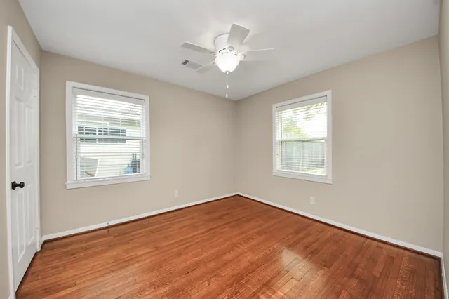 a view of a house with a backyard and a tree
