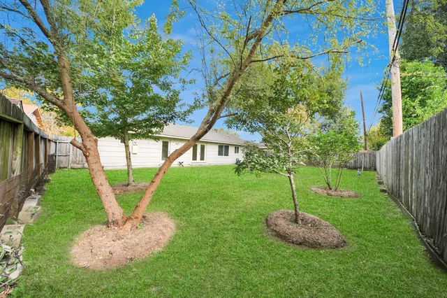 a kitchen with a refrigerator sink and cabinets