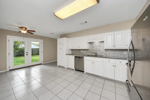 a large kitchen with a stove a sink dishwasher and a refrigerator