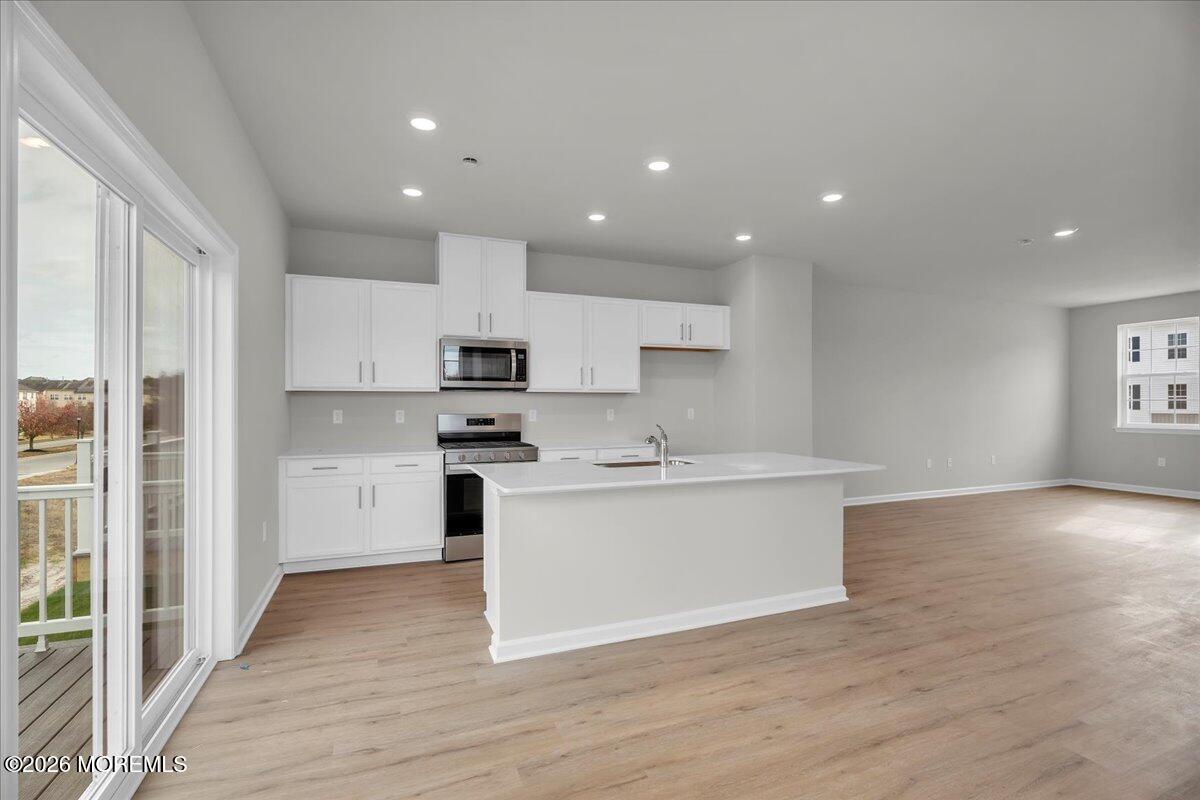 216 Sandy Rdg Road Sicklerville, NJ 08081 - Photo 11 of 24 a kitchen with a white wooden floor and white stainless steel appliances