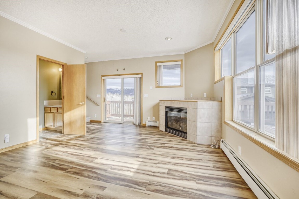 63 20 Grand Court, Unit 63 Silverthorne, CO 80498 - Photo 7 of 28 a view of a livingroom with wooden floor and a fireplace