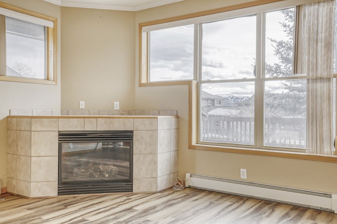 63 20 Grand Court, Unit 63 Silverthorne, CO 80498 - Photo 9 of 28 a view of an empty room with wooden floor and a window