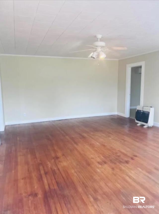 1059 Alabama Street Loxley, AL 36551 - Photo 2 of 12 Unfurnished room with crown molding, wood-type flooring, heating unit, and ceiling fan