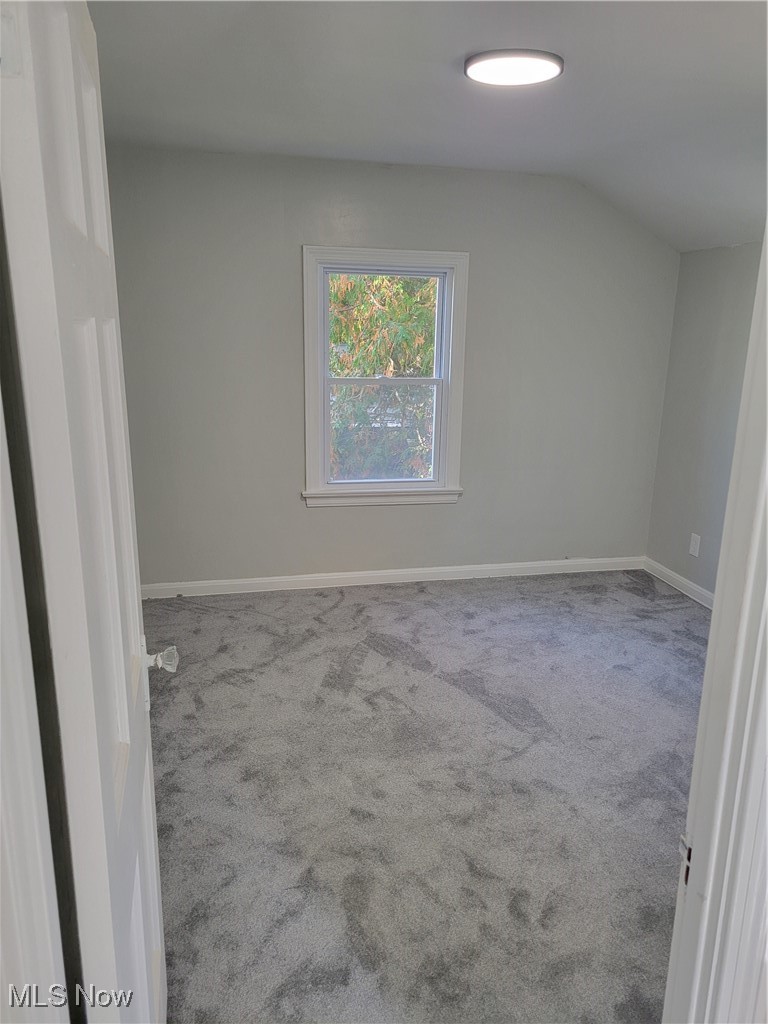 1685 Oakmount Road Cleveland, OH 44121 - Photo 15 of 23 Additional living space with light colored carpet and vaulted ceiling