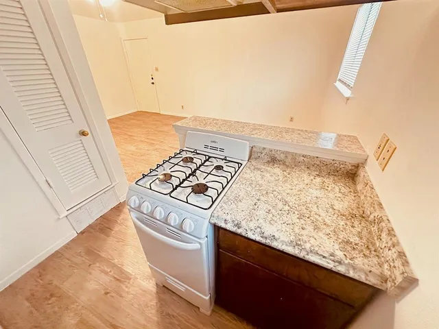 a kitchen with a stove and a white cabinet