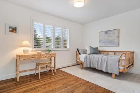 a bedroom with a bed and a potted plant