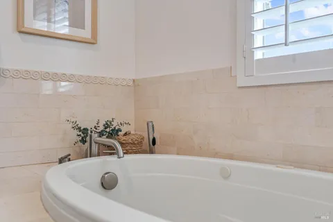 a view of a patio with table and chairs potted plants with wooden fence