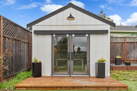 a backyard of a house with yard and outdoor seating