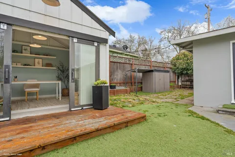 a backyard of a house with table and chairs