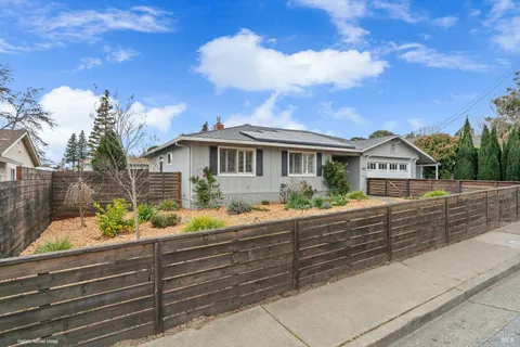 a view of house with outdoor space and sitting area