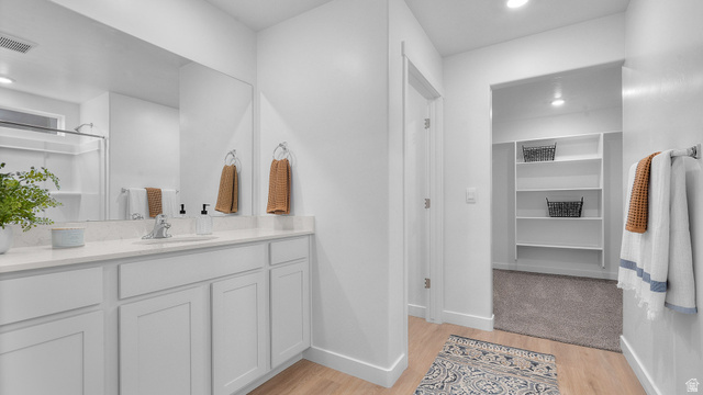 2032 East Dorset Way, Unit 286 Salem, UT 84653 - Photo 17 of 23 Bathroom featuring an expansive vanity with a light-toned countertop and integrated sink, a large wall mirror, and a built-in shower with a white surround