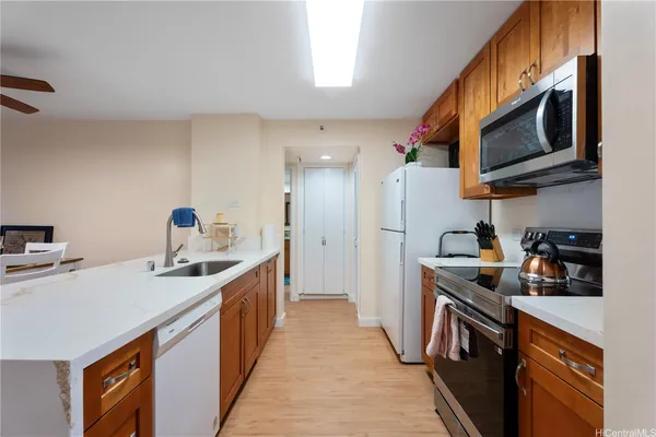 a kitchen with stainless steel appliances granite countertop a sink stove and refrigerator