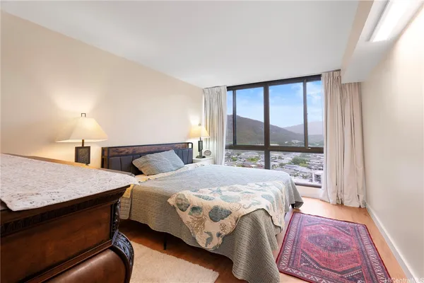 a bedroom with a bed lamp and a window