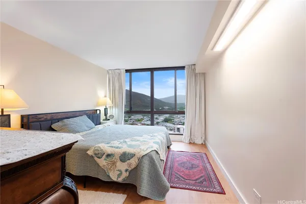 a bedroom with a bed window and a table